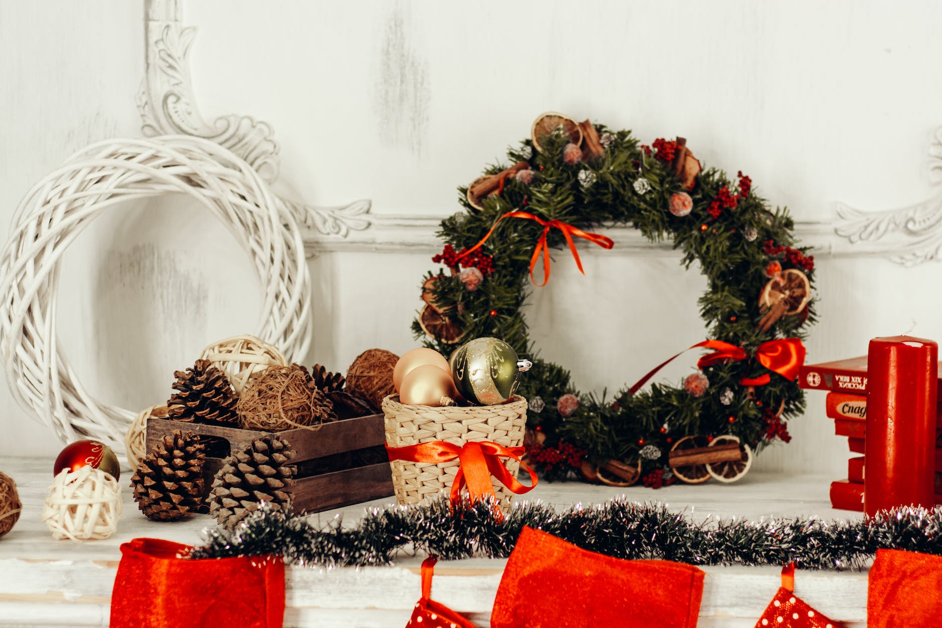 pine cones and christmas wreaths placed on white table