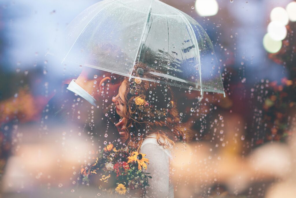 couple under see through umbrella due to the rain