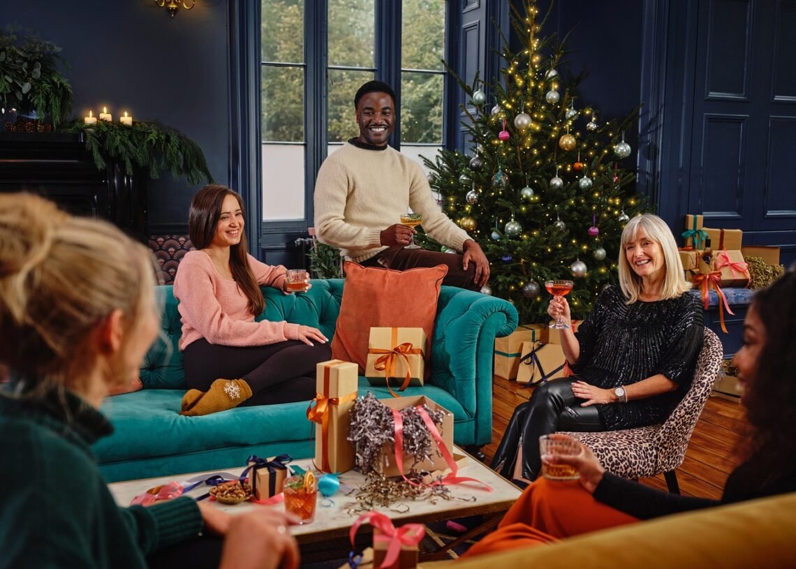 family and friends sharing a drink and Christmas gifts