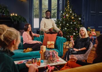 family and friends sharing a drink and Christmas gifts