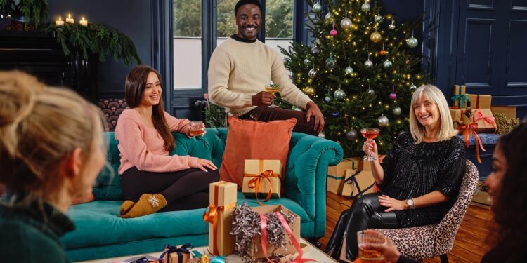 family and friends sharing a drink and Christmas gifts