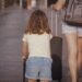 Woman and child walking with luggage while traveling